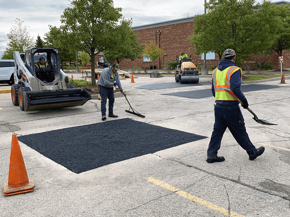 Asphalt patch repair on a residential driveway