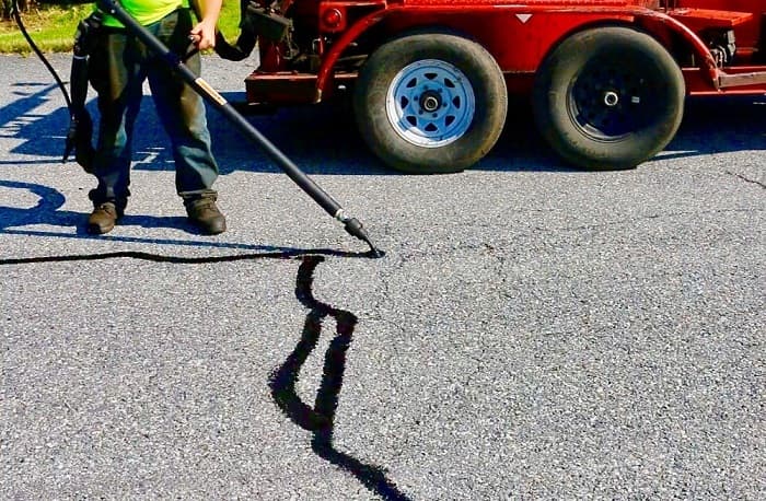 Hot-pour crack filling on an asphalt driveway